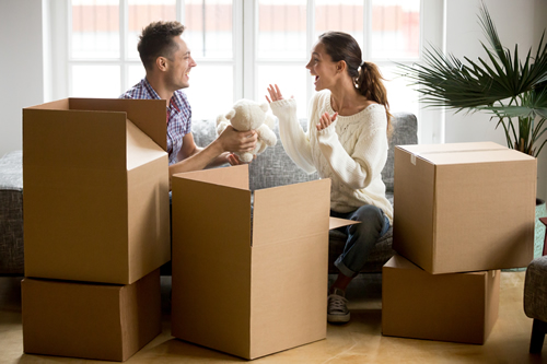 Couple unpacking boxes